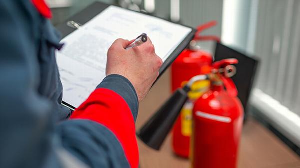 Close up of person doing a fire risk assessment in equine centre